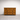 Wooden dresser with six drawers on a plain background