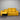 Yellow sectional sofa against a metallic wall.