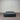 Charcoal fabric, bed base, made in New Zealand, pine wood, corner guard protection, on a gray floor with a striped wall background