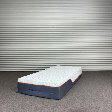 Mattress with I-REST FITNESS branding against a metallic wall.