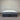 Gray and white mattress with 'Penzance' branding against a striped wall.