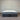 Gray and white mattress with 'Penzance' branding against a striped wall.
