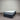 Mattress with 'Chelsea' branding on a gray floor against a corrugated metal wall.