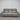 Gray leather sofa in front of a metallic shutter door.