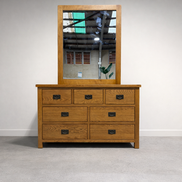 Wooden dresser with mirror on a plain background