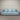 Light blue sofa against a striped wall.