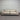 Beige leather sofa against a striped wall.