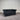 Black leather sofa against a gray wall