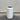 White cylindrical trash can with black interior on a wooden floor against a gray wall.