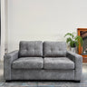Gray sofa in a room with a plant and wooden cabinet.