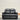 Black leather sofa against a beige wall