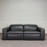 Black leather sofa against a striped wall.