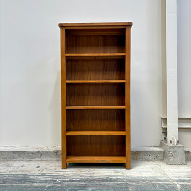 Wooden bookshelf against a white wall