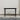 Black table against a plain wall on a wooden floor