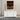 White dresser with a mirror on top in a warehouse setting