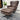 Brown leather armchair with ottoman on a wooden floor
