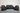 Black leather reclining sofa set on a wooden floor with a neutral background