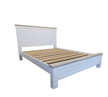 White wooden bed frame with slatted bed base on a white background