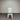 White chair with a gray cushion against a corrugated metal wall. Kinloch collection