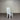 White chair with a gray cushion against a corrugated metal wall. Kinloch Collection.