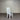 White chair with a gray cushion against a corrugated metal wall. Kinloch Collection.