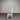 White chair with a gray cushion against a metallic background. Kinloch collection