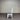 White chair with a gray cushion against a metallic background. Kinloch collection