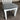 White chair with a gray cushioned seat on a carpeted floor. Kinloch Collection