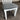 White chair with a gray cushioned seat on a carpeted floor. Kinloch Collection