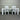 White dining table with four chairs against a corrugated metal wall. Kinloch collection