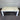 White wooden table against a metallic shutter background