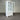 White cabinet with glass doors and drawers against a striped wall.