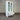 White cabinet with glass doors and a drawer in front of a striped wall.