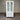White cabinet with glass doors and drawers against a corrugated metal background