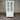 White cabinet with glass doors and drawers against a corrugated metal wall.