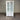 White cabinet with glass doors and drawers against a striped wall.