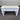 White wooden table with two drawers on a gray floor.