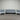 Outdoor furniture set with gray cushions on a metal wall background