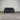 Black sofa against a corrugated metal wall