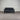 Black sofa against a corrugated metal wall