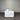 White sofa in a room with a corrugated metal wall.