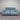 Blue power sofa with black metal legs, extended headrests, against a striped wall