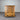 Wooden dresser with four drawers against a corrugated metal background