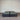 Charcoal fabric, bed base, made in New Zealand, pine wood, corner guard protection, on a gray floor with a striped wall background