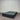 Charcoal fabric, bed base, made in New Zealand, pine wood, corner guard protection, on a gray floor with a striped wall background