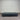 Charcoal fabric, bed base, made in New Zealand, pine wood, corner guard protection, on a gray floor with a striped wall background