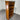 Wooden bookshelf with a drawer against a corrugated metal wall. Wanaka collection