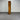 Tall wooden cabinet against a metallic shutter background - wanaka collection