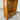 Wooden bookshelf with a single drawer on a concrete floor. wanaka collection.