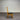 Wooden chair with a black seat on gray floor side view - Wanaka Collection